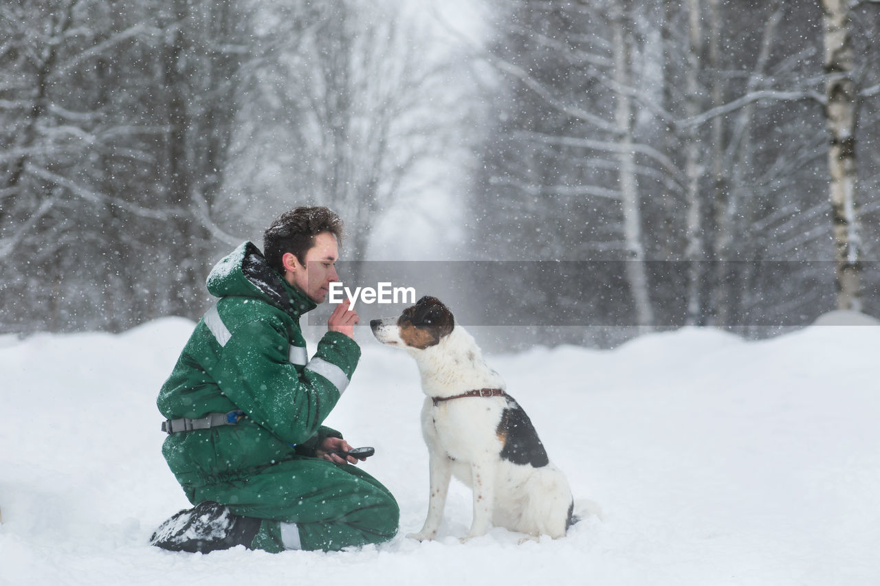 Full length of man with dogs during winter