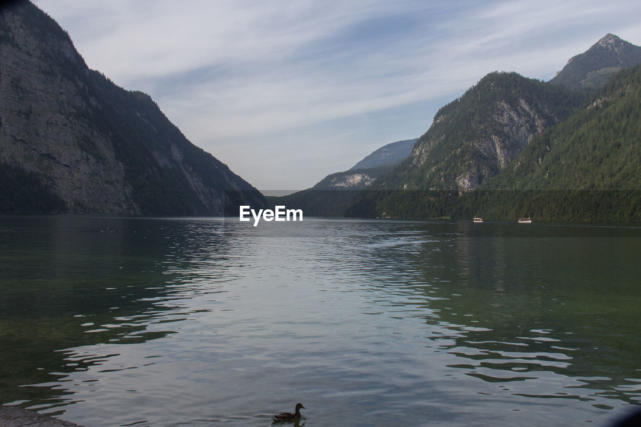 Scenic view of lake and mountains against sky