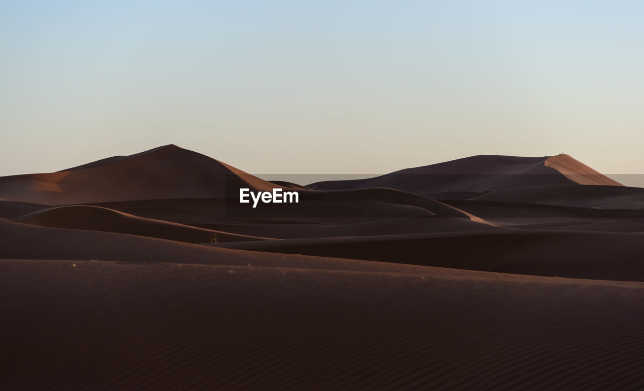 Scenic view of desert against clear sky