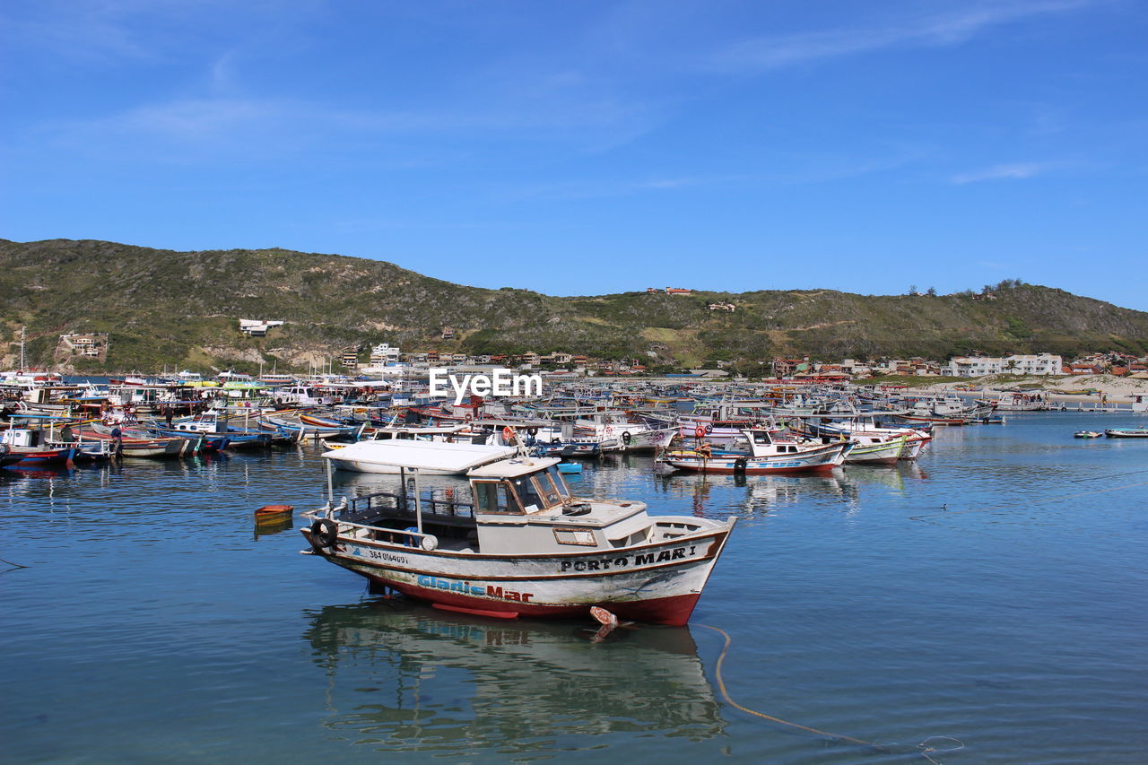 BOATS MOORED IN SEA