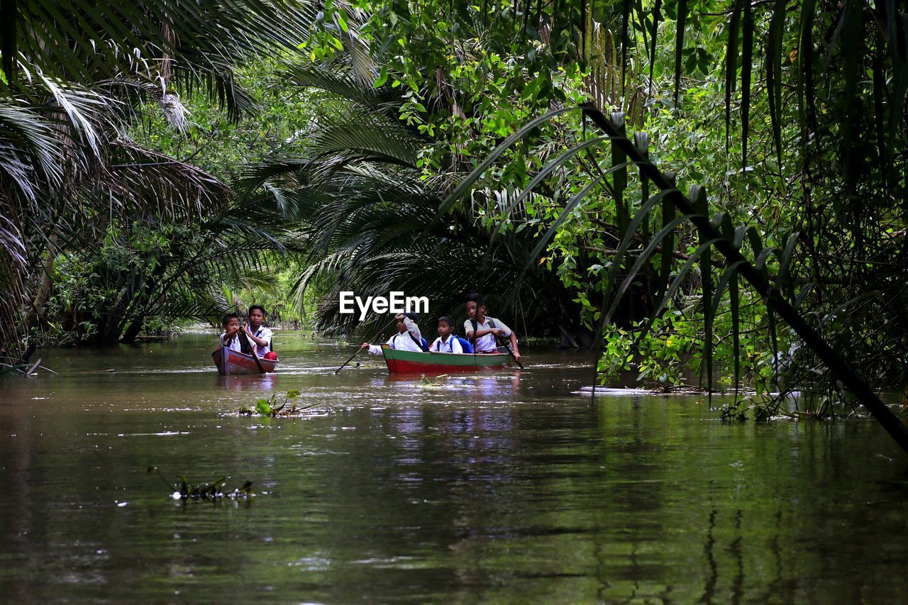 GROUP OF PEOPLE IN LAKE