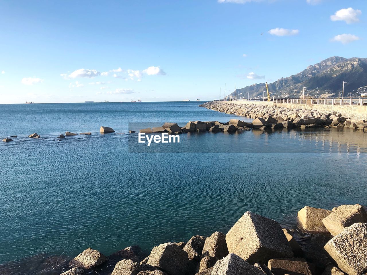 SCENIC VIEW OF SEA BY ROCKS AGAINST SKY