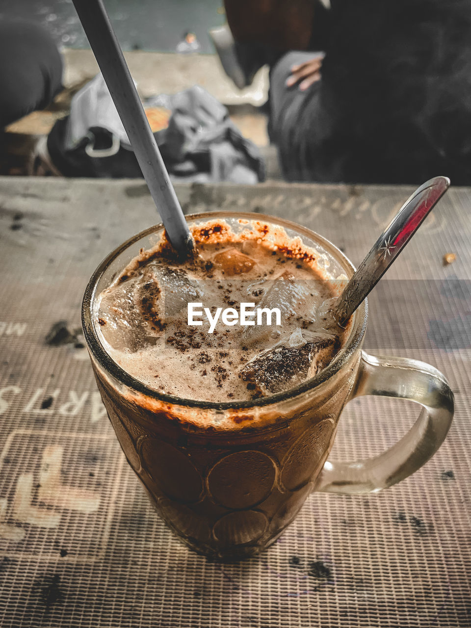 CLOSE-UP OF COFFEE CUP ON GLASS