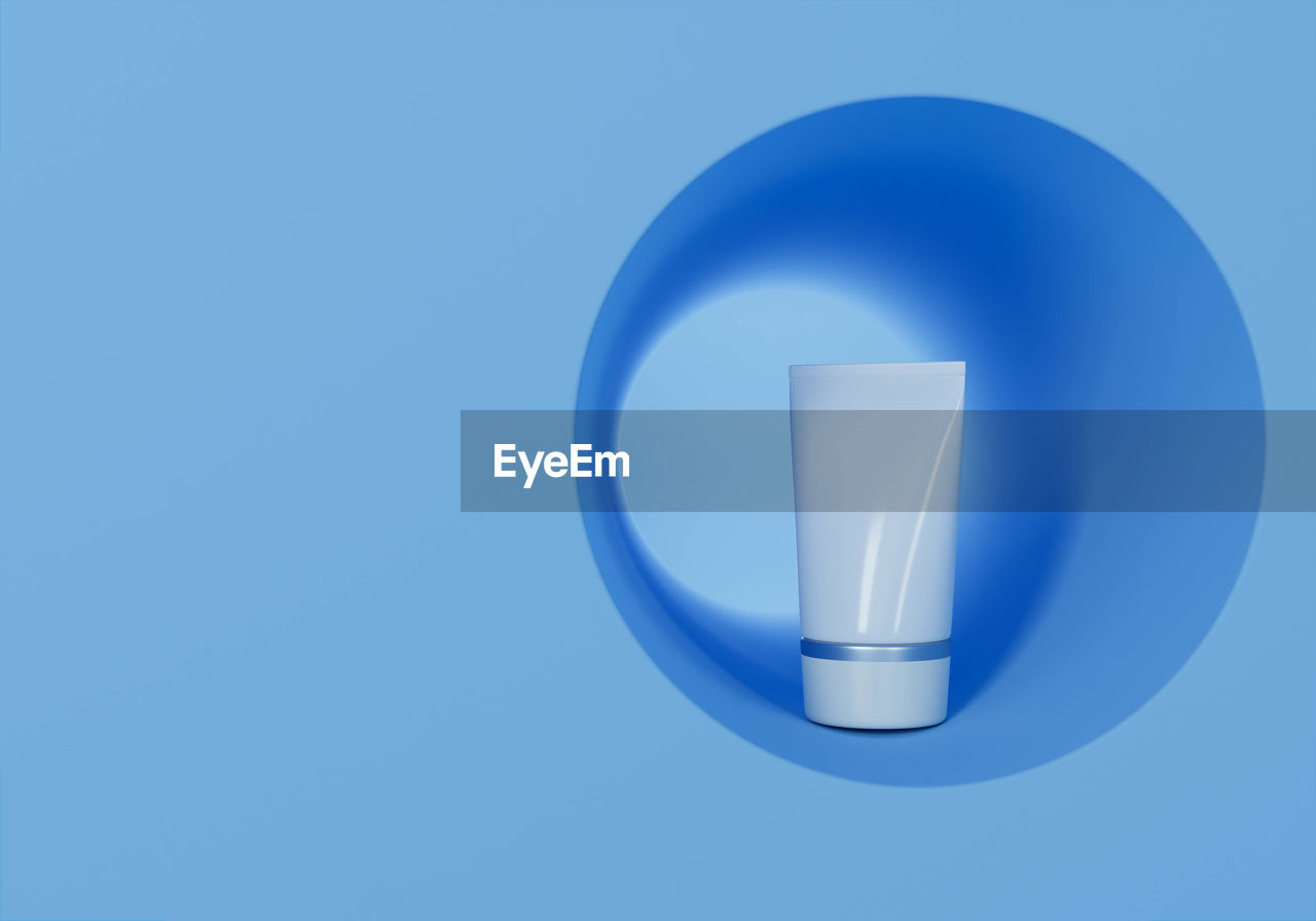 CLOSE-UP OF LAMP AGAINST BLUE BACKGROUND