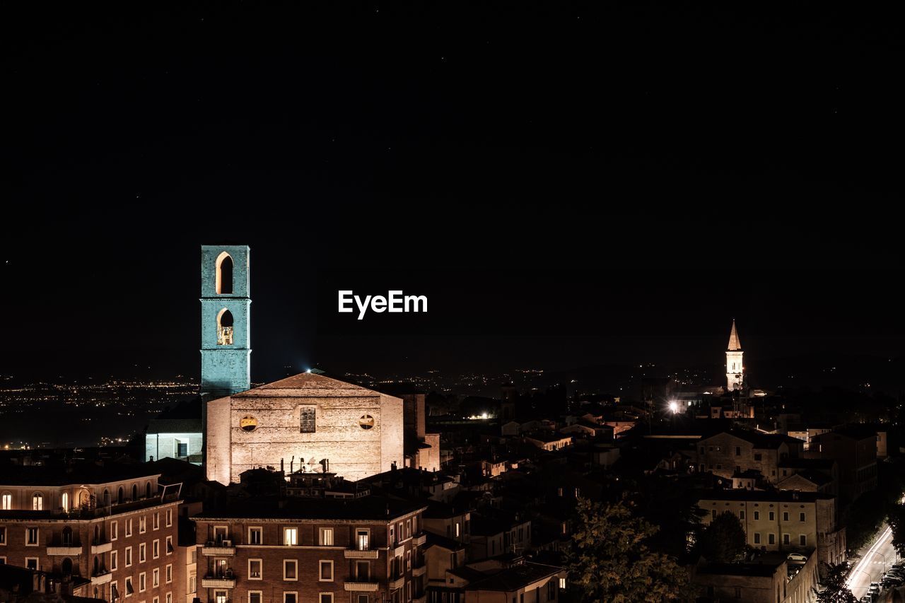 ILLUMINATED BUILDINGS AGAINST SKY AT NIGHT