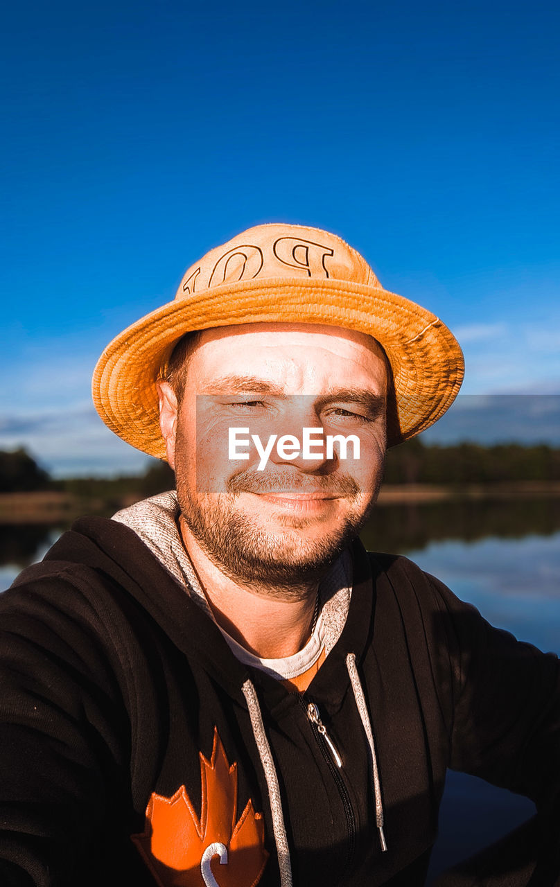 Portrait of man wearing hat against sky