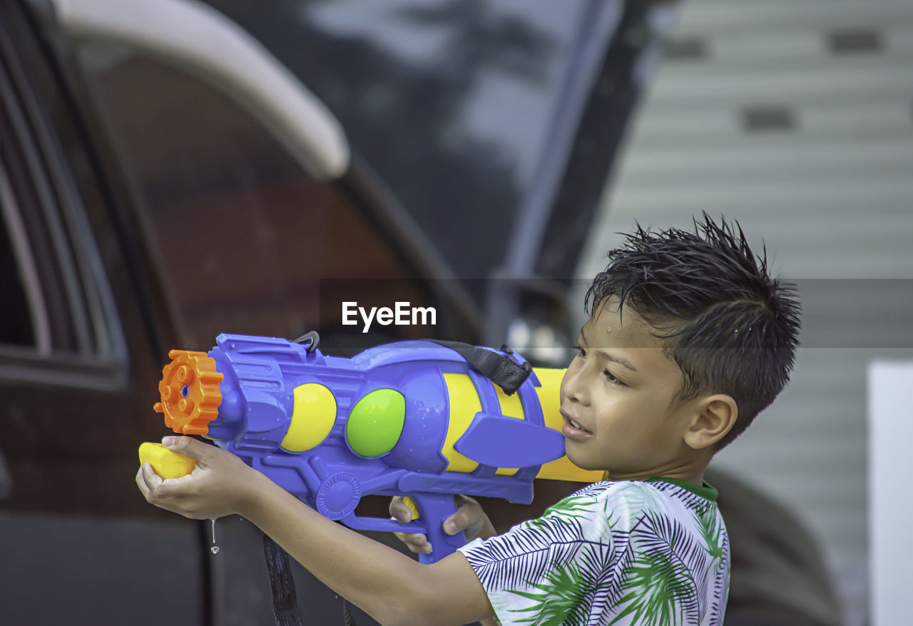 Boy playing with squirt gun