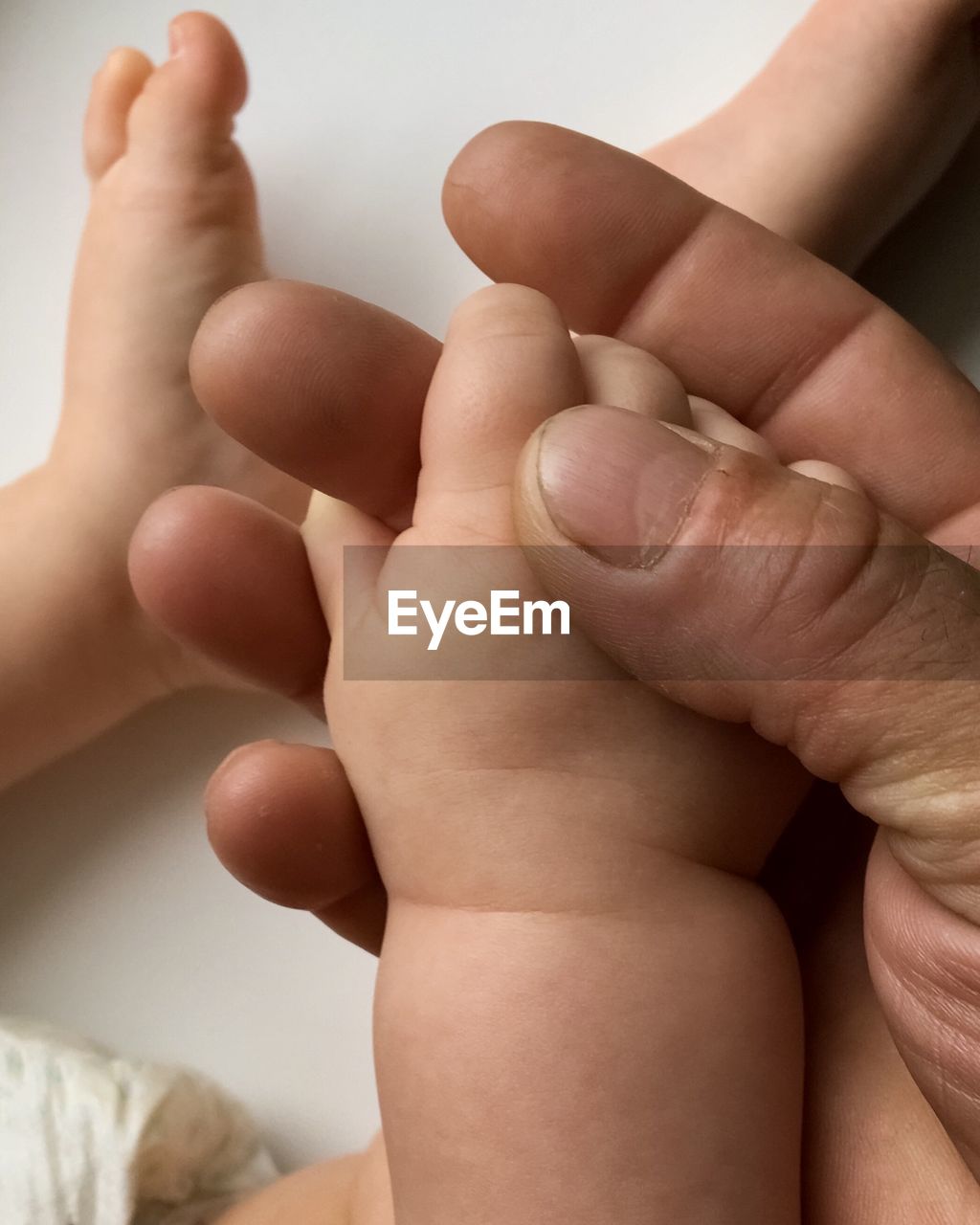 Baby holding his grandfather finger, close-up