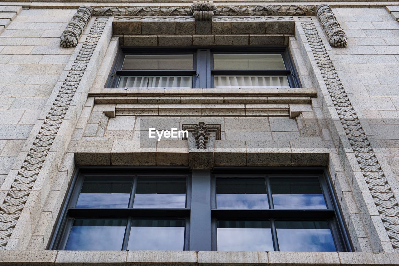 LOW ANGLE VIEW OF TEXT ON BUILDING WALL