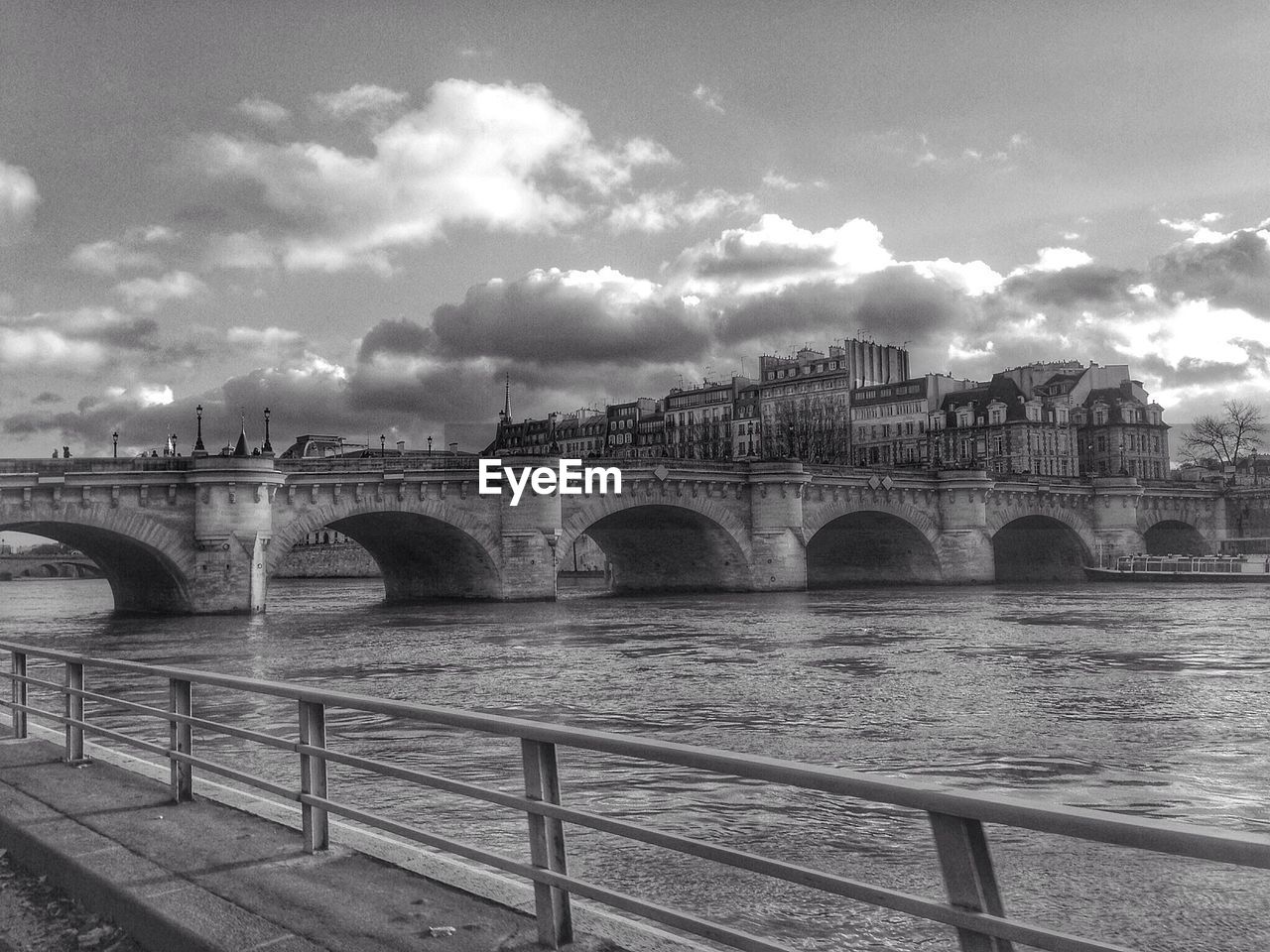 Arch bridge with city in background