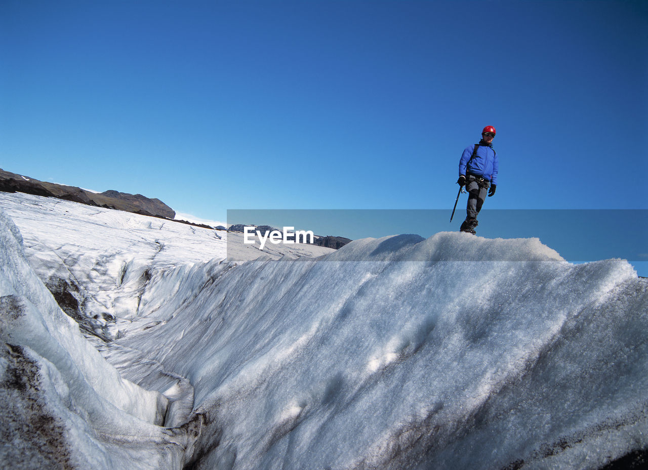 Man exploring the glacier solheimajokull in iceland