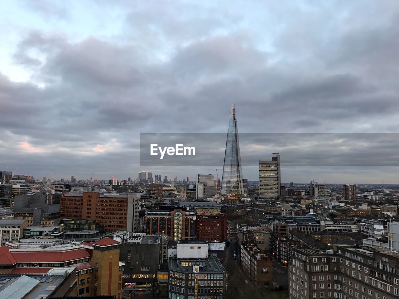 Cityscape against cloudy sky