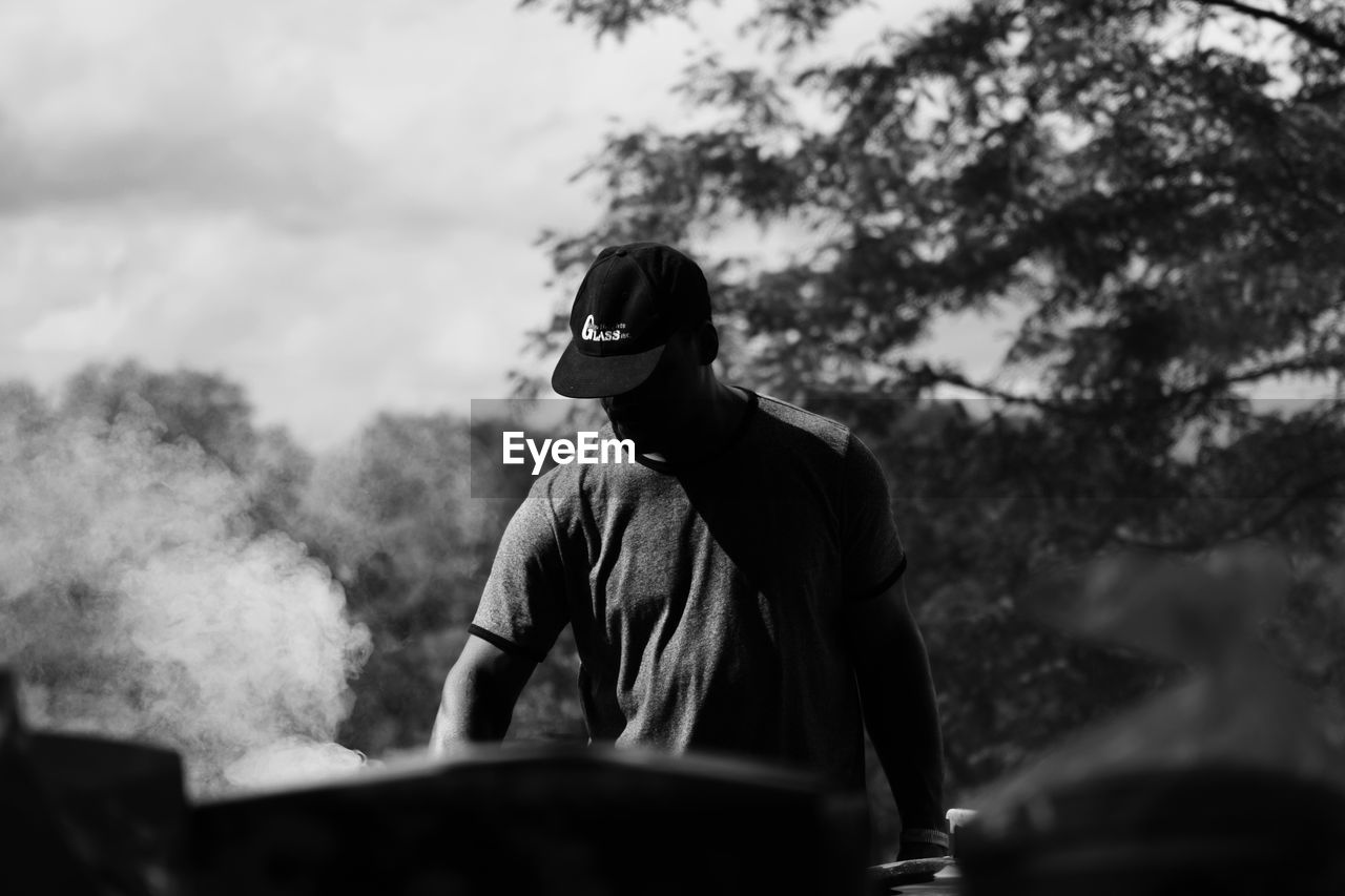 MAN WEARING MASK AGAINST TREES