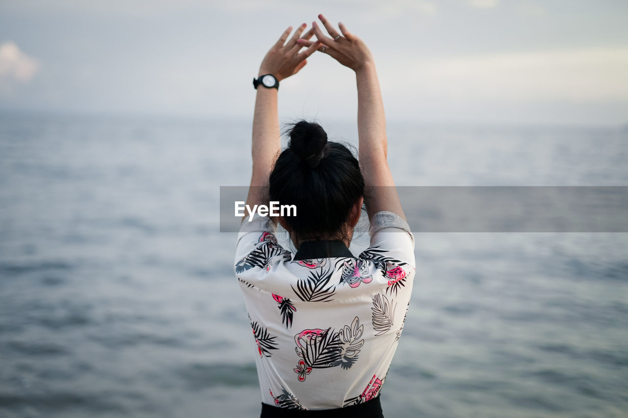 The photo behind the woman standing on the beach. beautiful sea background