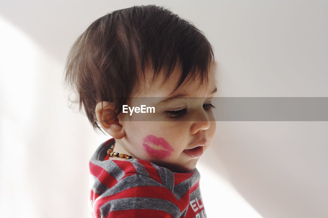 Portrait of toddler with lipstick kiss