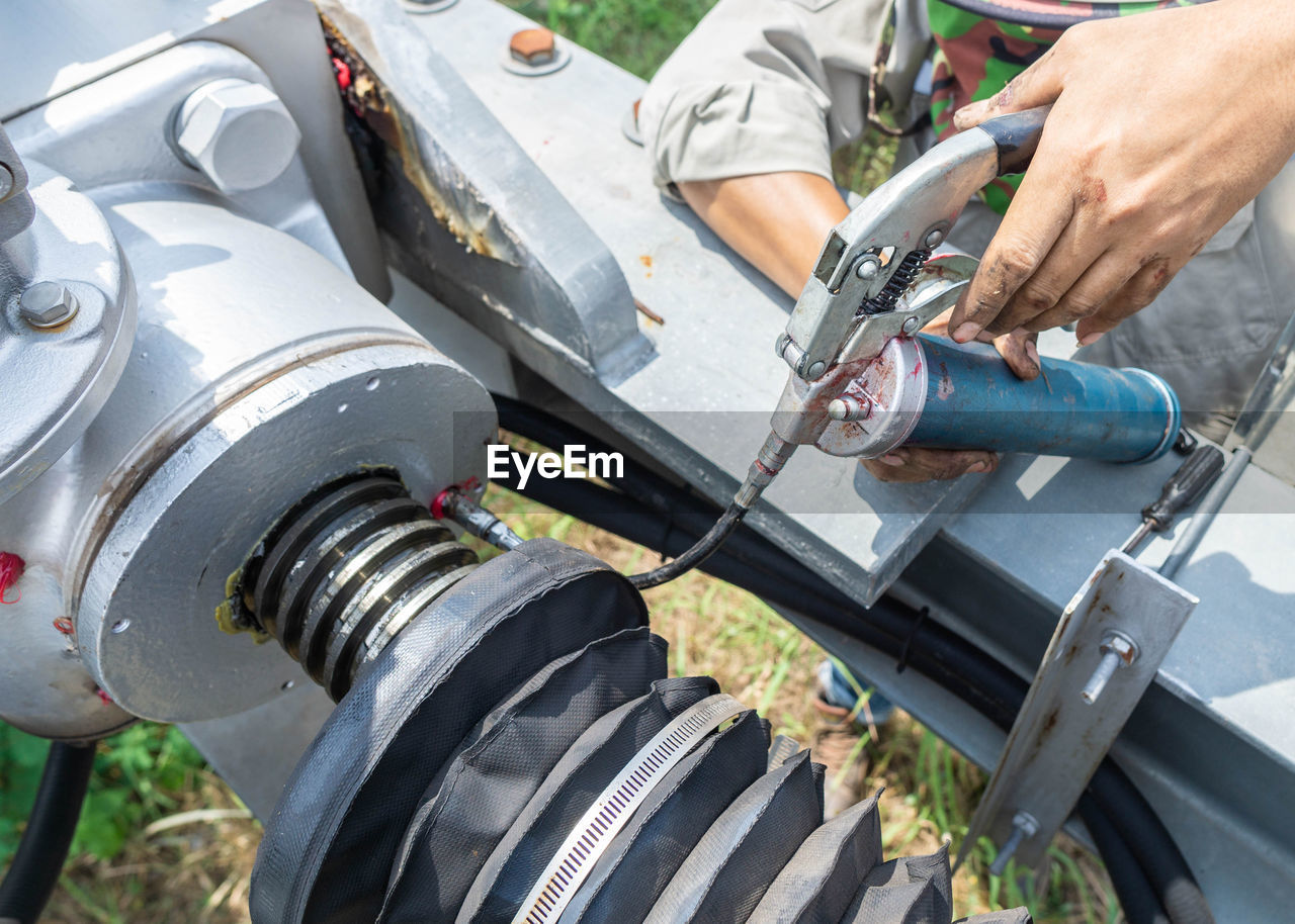 Cropped hands of man holding equipment