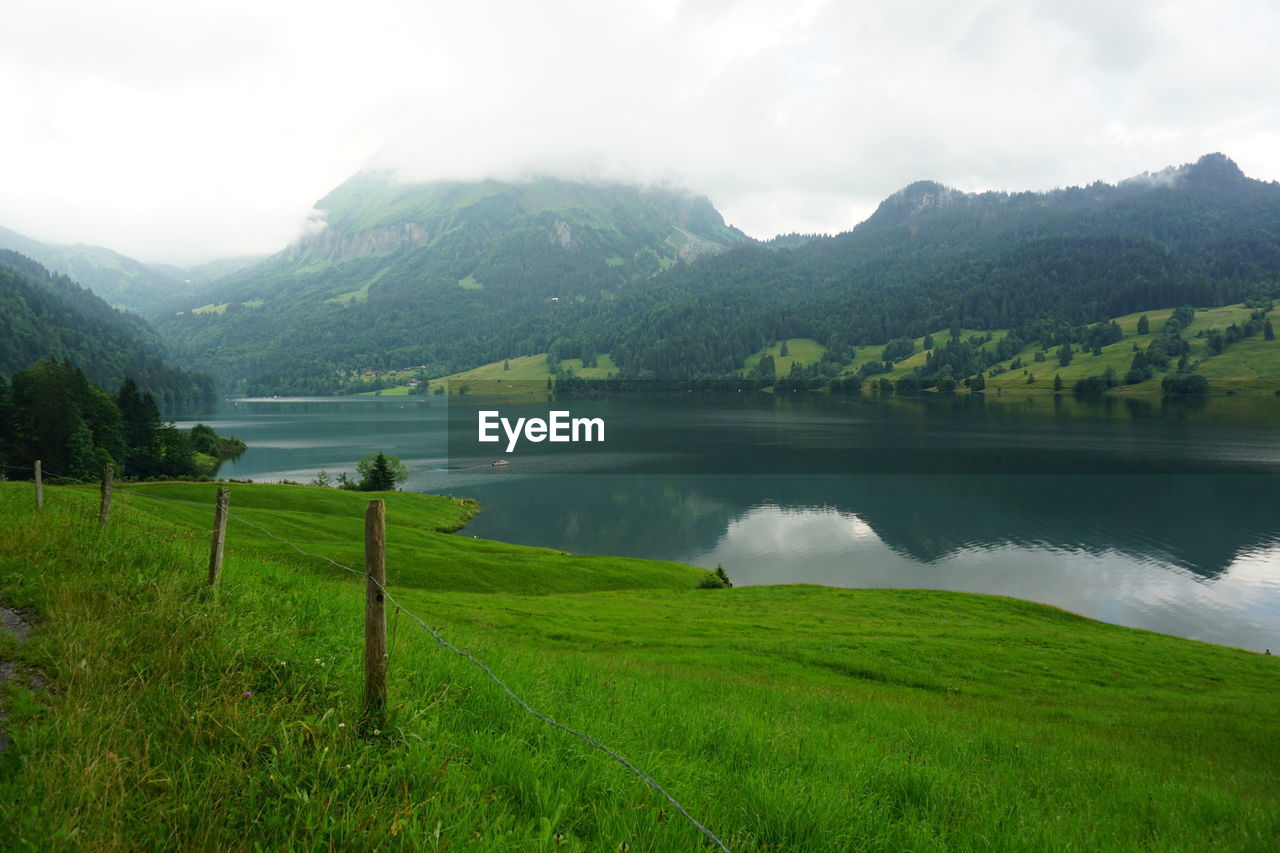 Scenic view of lake and mountains against sky