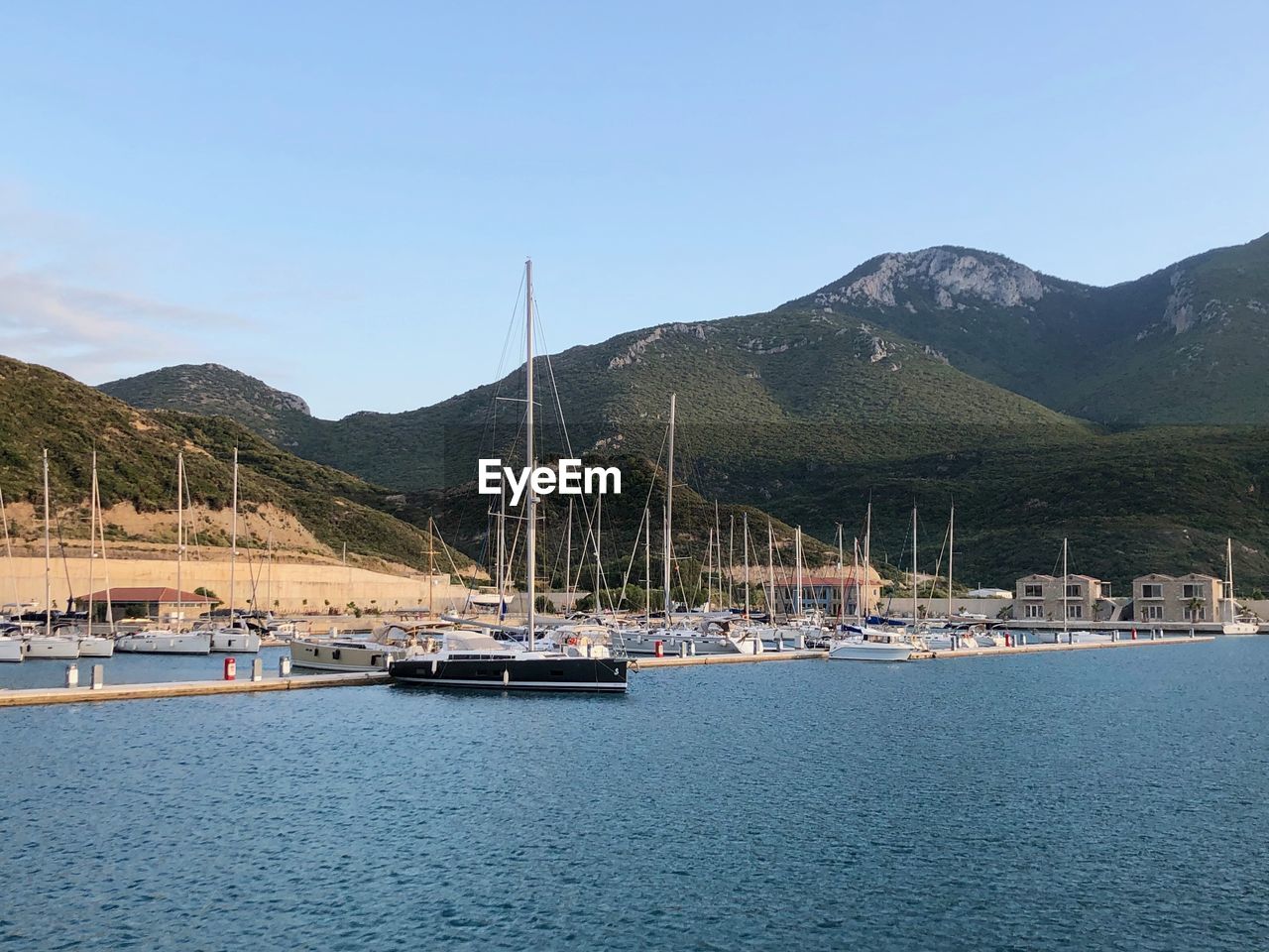 Sailboats in sea against sky