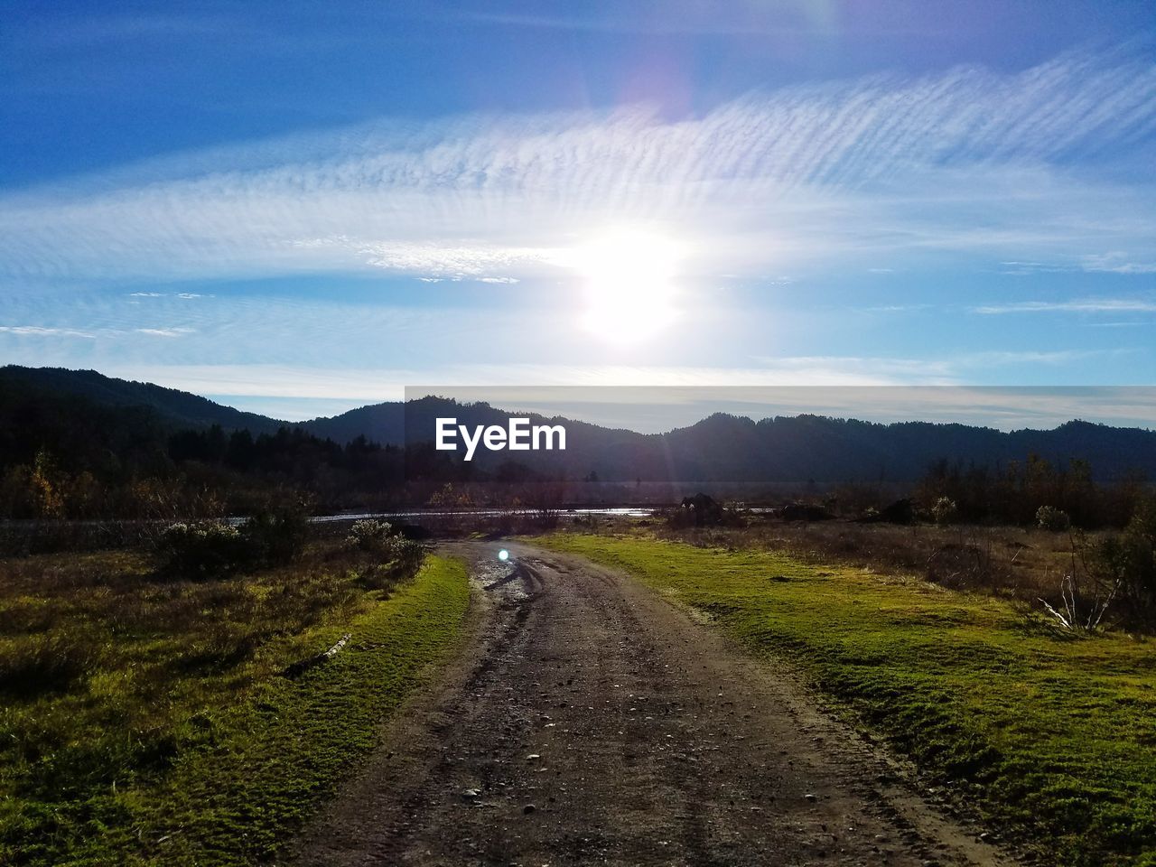 Road amidst landscape against sky