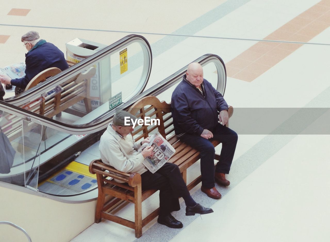 REAR VIEW OF PEOPLE SITTING IN OFFICE