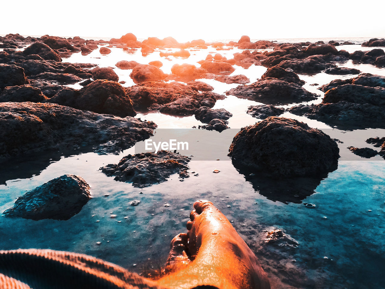 Scenic view of rocks in sea against sky