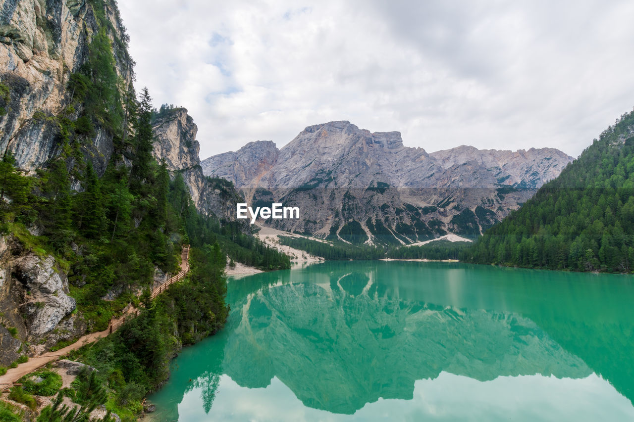 Scenic view of lake by mountains against sky