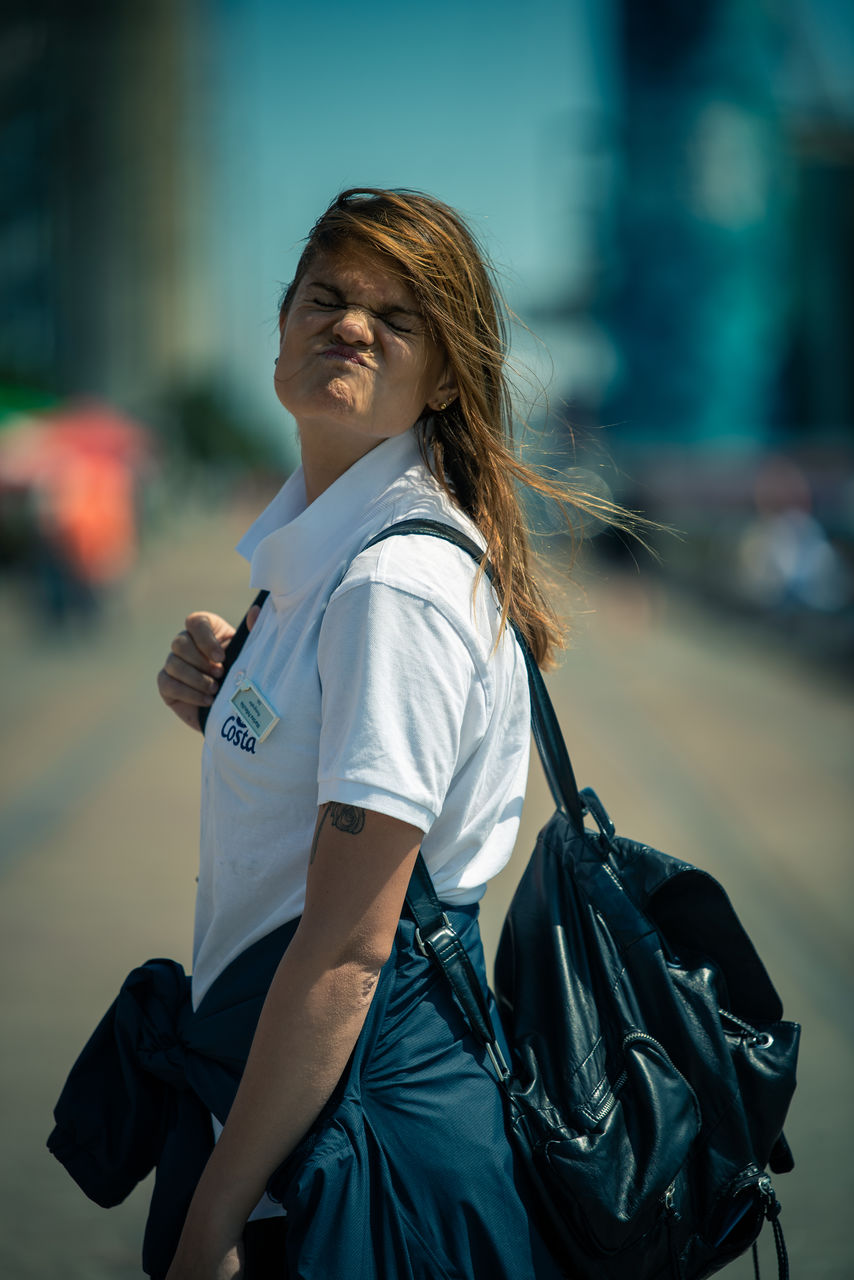 MIDSECTION OF WOMAN HOLDING CAMERA