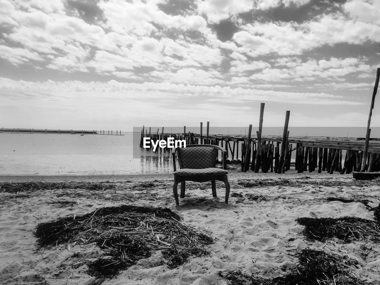 CHAIR ON BEACH AGAINST SKY