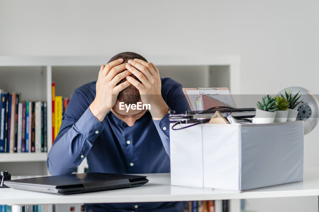 Depressed businessman sitting in office