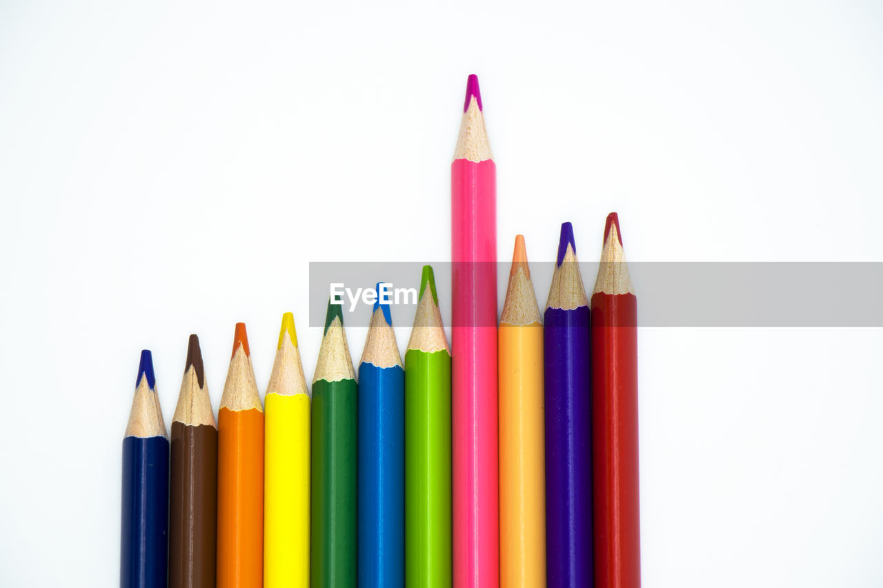 Close-up of colored pencils against white background