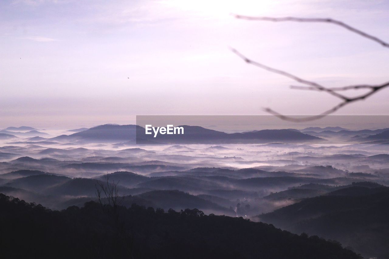 Scenic view of silhouette mountains against sky at sunset