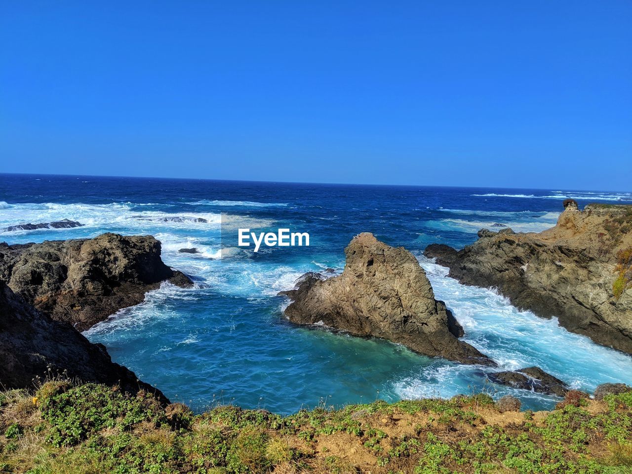 Scenic view of vast ocean from sandstone cliffs.