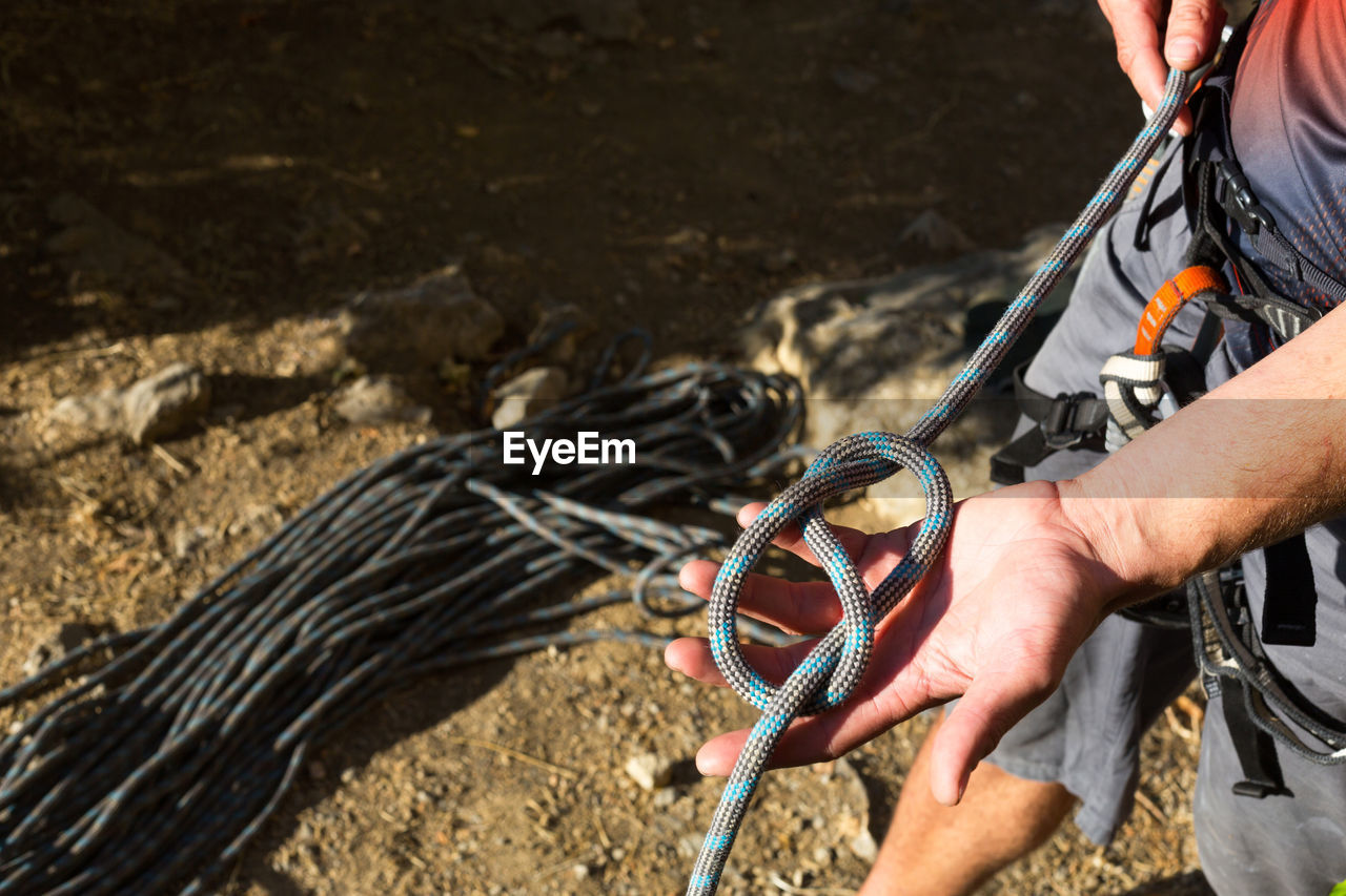 Close-up of man working with rope