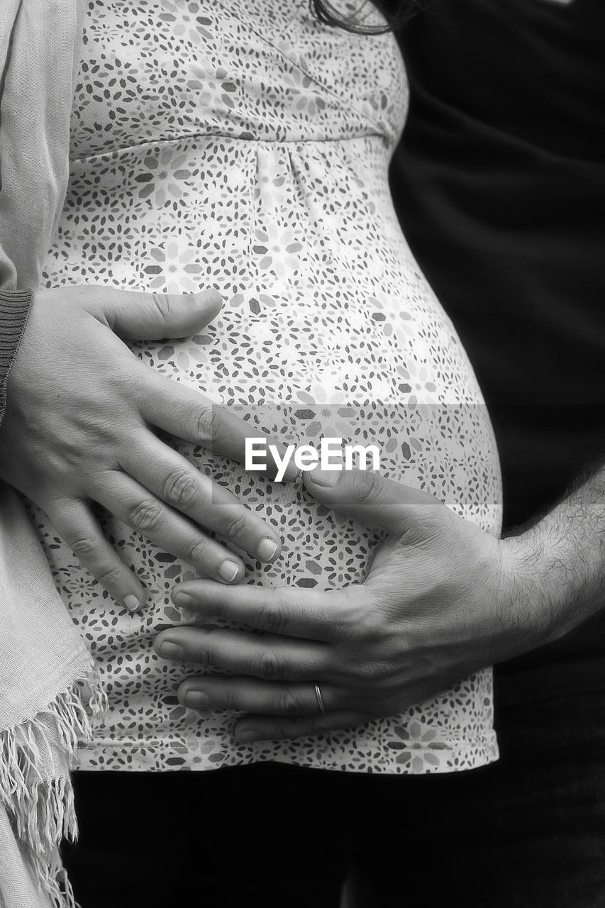 CLOSE-UP OF HANDS HOLDING BABY TOUCHING