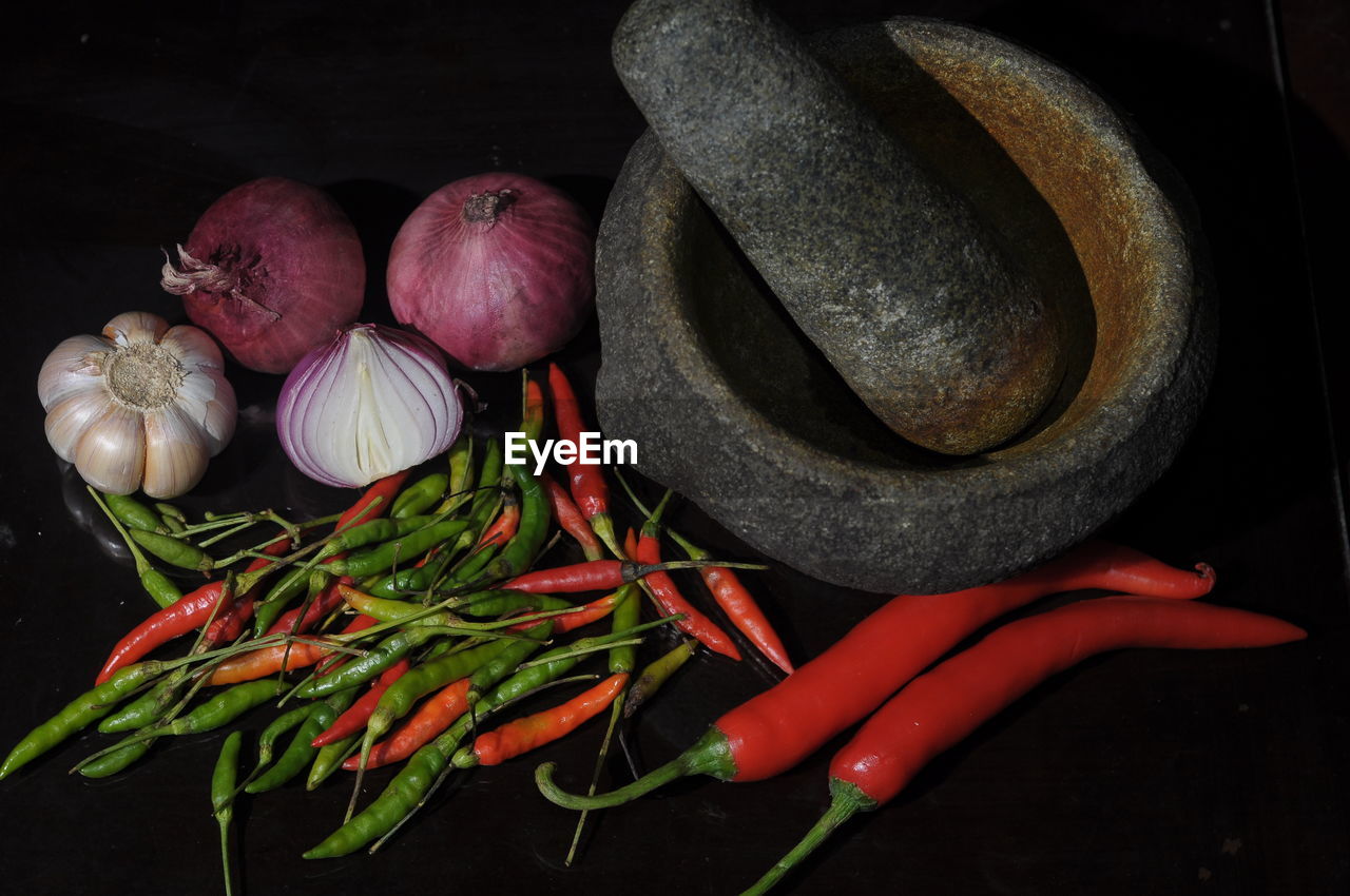 CLOSE-UP OF RED CHILI PEPPERS IN KITCHEN