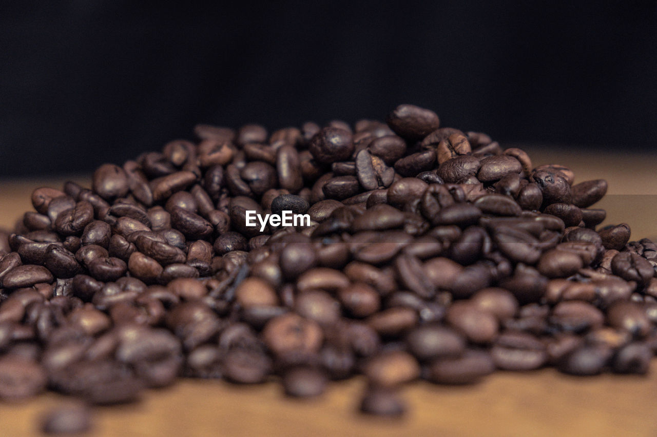 Close-up of roasted coffee beans on table