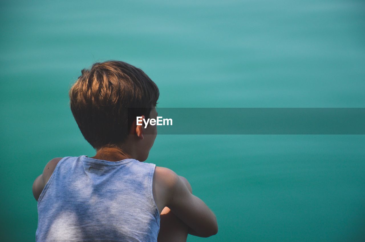 Rear view of boy against sea