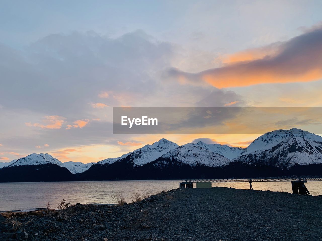 Scenic view of snowcapped mountains against sky during sunset