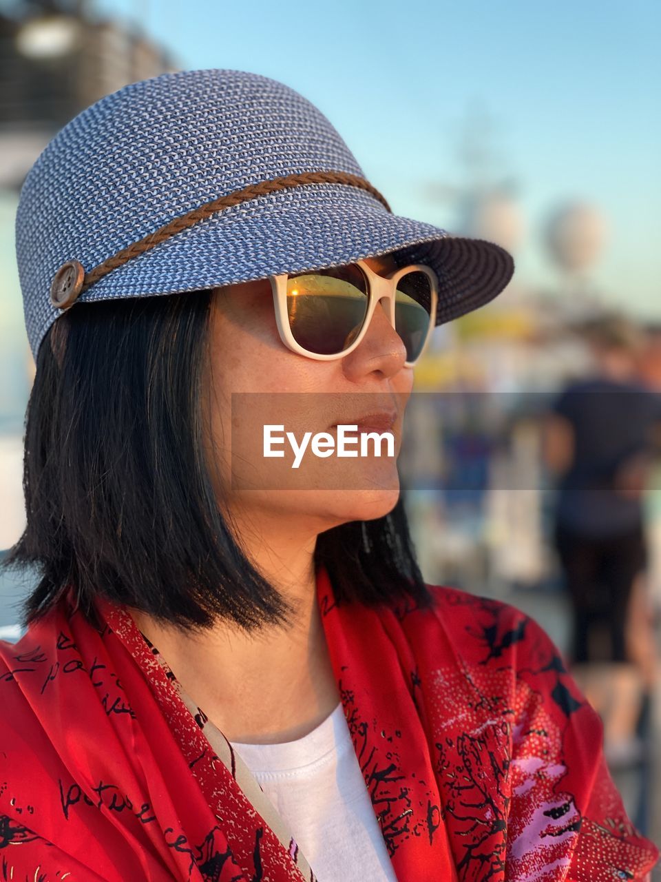 Close-up of woman wearing sunglasses and hat outdoors