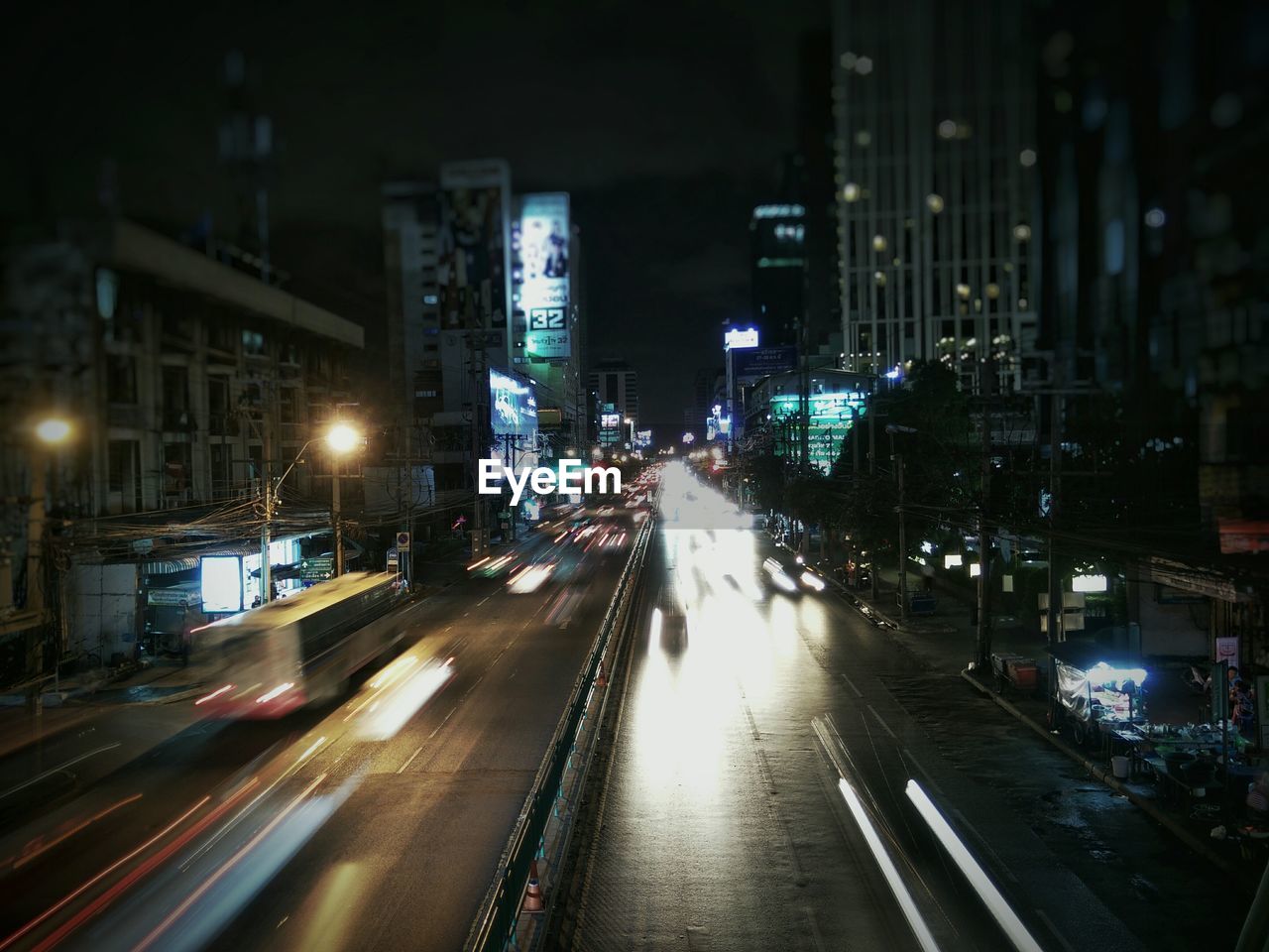 Light trails on road along buildings at night