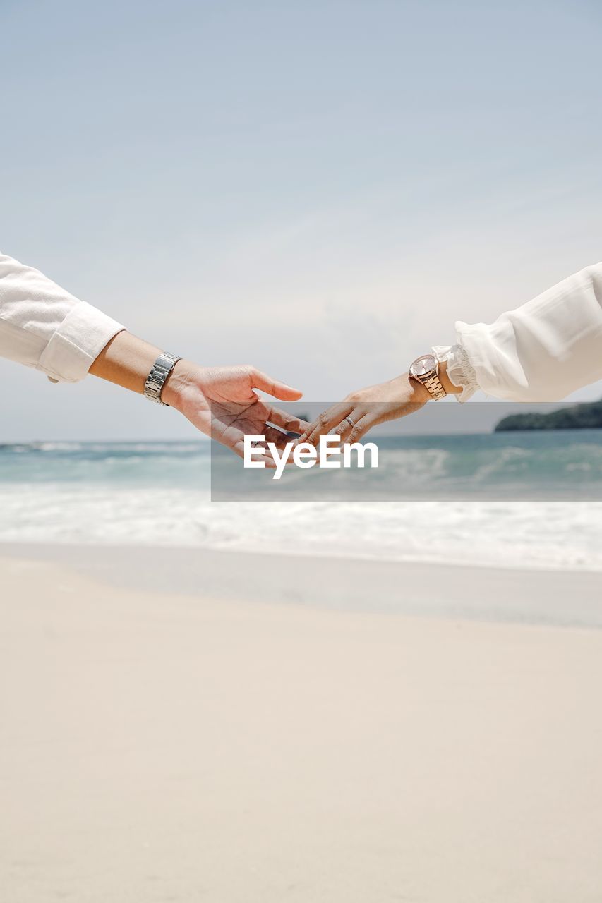 People on beach against sky