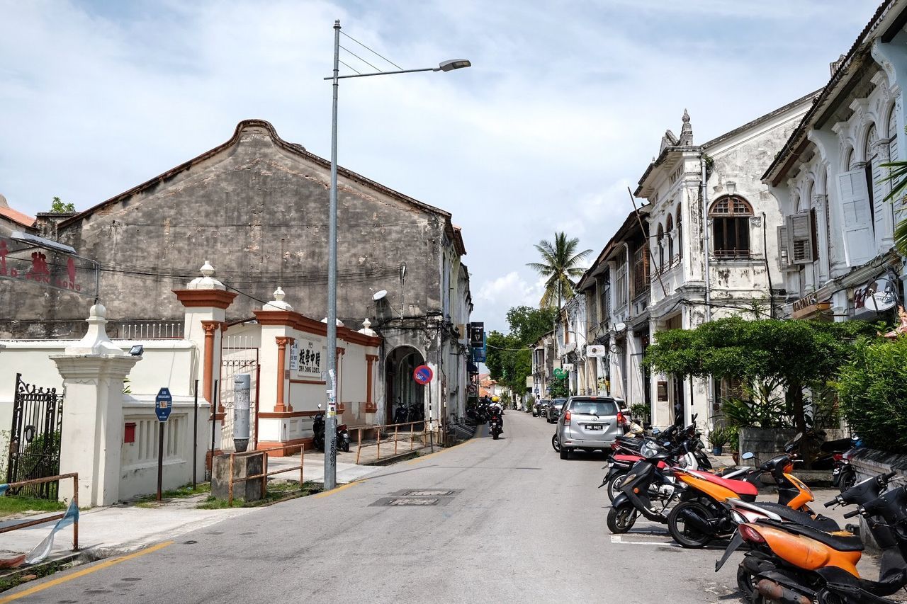 Street amidst buildings in city against sky