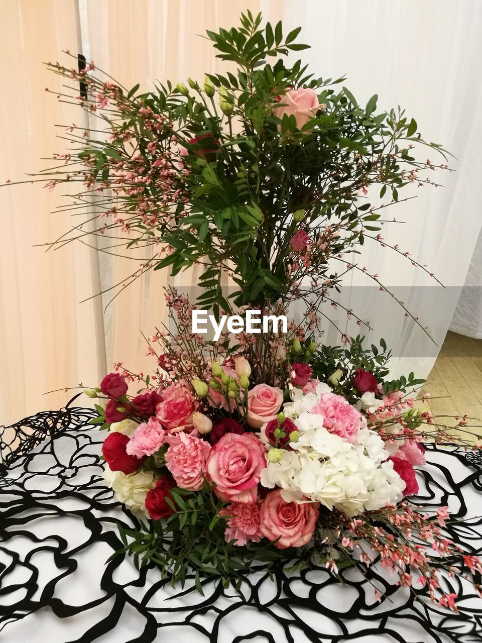 CLOSE-UP OF VASE ON TABLE