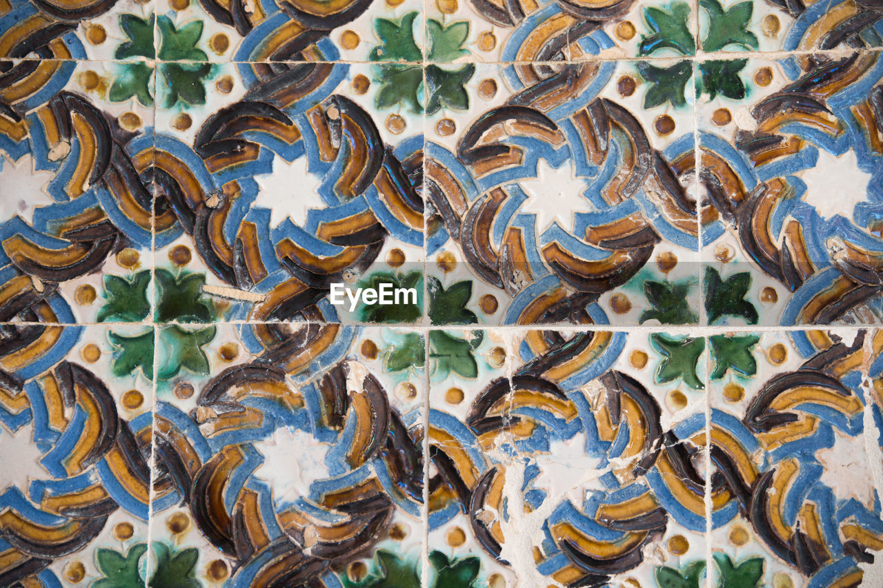 Retro style tiles in a wall. green, blue and brown color