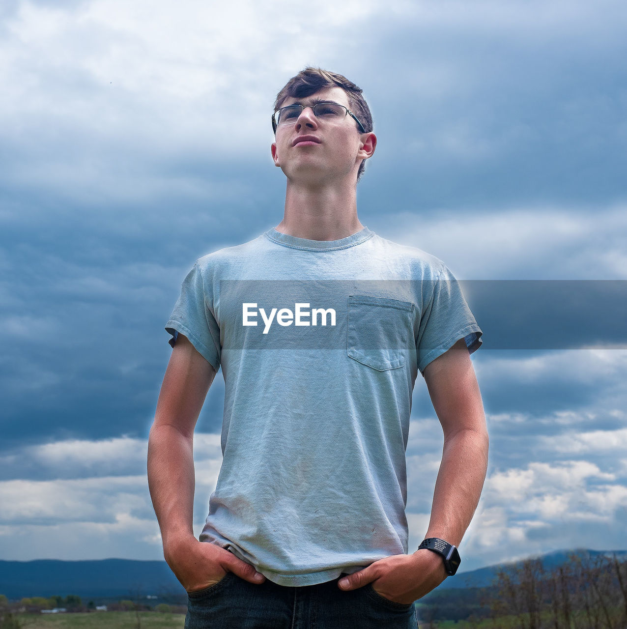 YOUNG MAN LOOKING AGAINST SKY