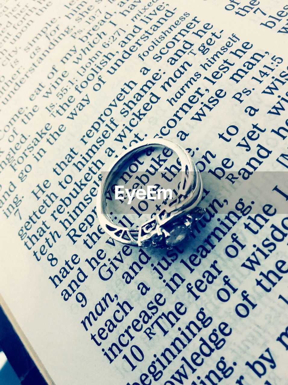 Close-up of ring on open book