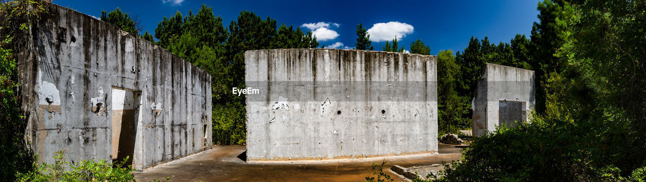 VIEW OF BUILT STRUCTURE WITH TREES IN BACKGROUND