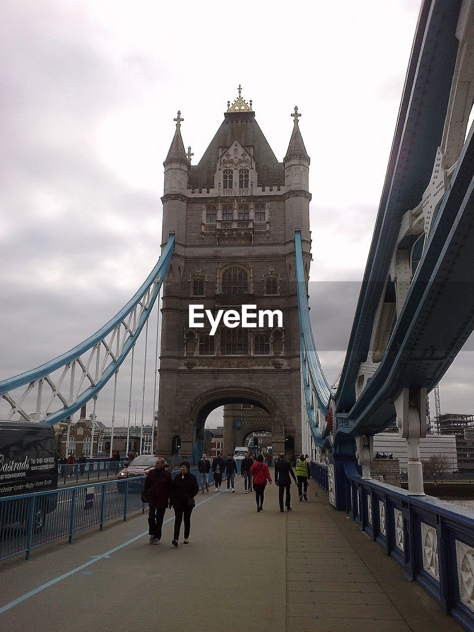 Low angle view of people walking on suspension bridge