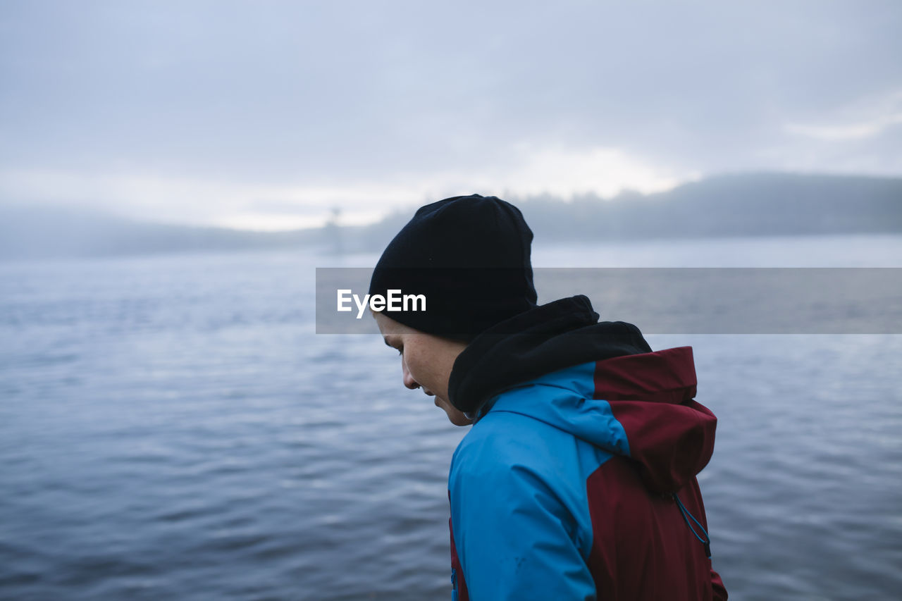 Female hiker at lake looking away