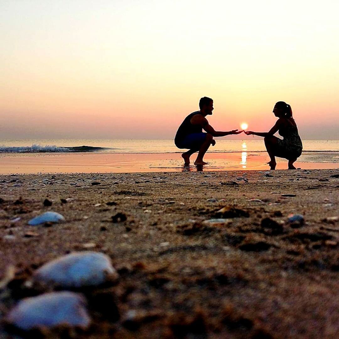 SURFACE LEVEL OF BEACH AT SUNSET